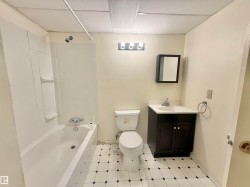 Bathroom featuring vanity, shower / tub combination, a paneled ceiling, and light flooring - 