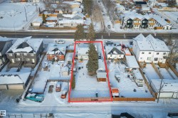 Snowy aerial view with property boundaries highlighted and a residential view - 
