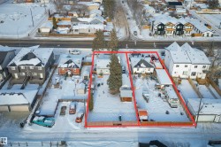 Snowy aerial view featuring property boundaries highlighted and a residential view - 