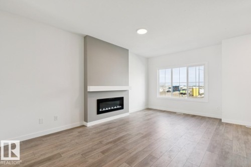 245 Wattle Road, Leduc, AB - Indoor Photo Showing Living Room With Fireplace