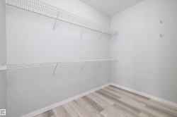 Walk in closet with light wood finished floors - 