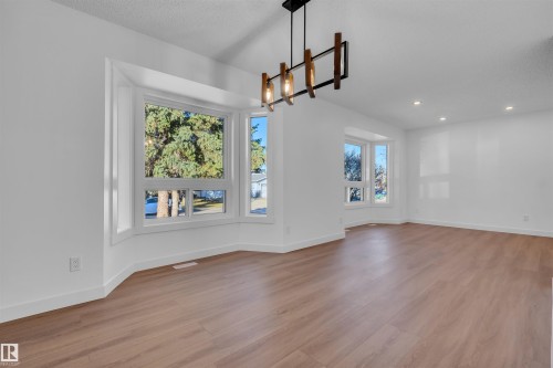 Unfurnished dining area featuring light wood-style floors, a textured ceiling, and recessed lighting - 1111 49A Street, Edmonton, AB - Indoor Photo Showing Other Room