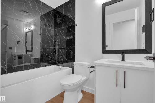 Full bathroom with vanity, a combined bath / shower with marble appearance, and light wood finished floors - 1111 49A Street, Edmonton, AB - Indoor Photo Showing Bathroom