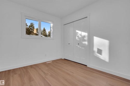 Unfurnished bedroom with light wood-type flooring and a closet - 1111 49A Street, Edmonton, AB - Indoor Photo Showing Other Room