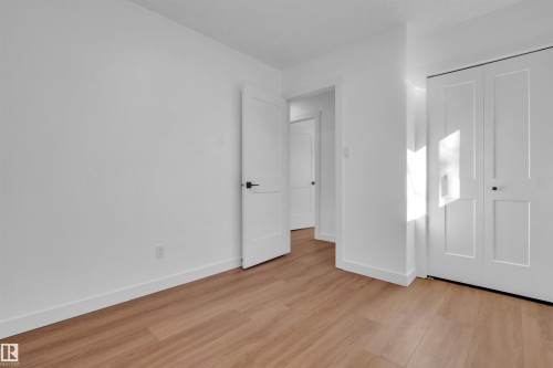 Unfurnished bedroom with light wood-style flooring and a closet - 1111 49A Street, Edmonton, AB - Indoor Photo Showing Other Room