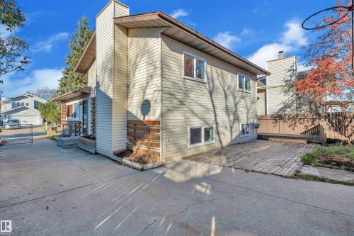 Back of house featuring a chimney, a wooden deck, and a gate - 1111 49A Street, Edmonton, AB - Outdoor