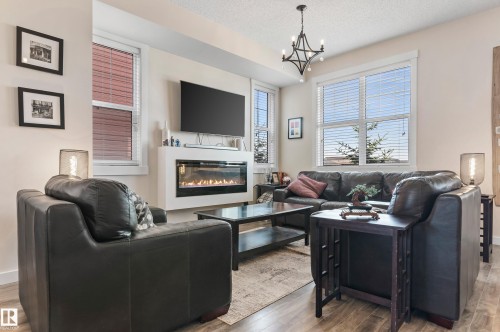 43 903 Crystallina Nera Way, Edmonton, AB - Indoor Photo Showing Other Room With Fireplace