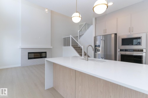 19004 20 Avenue, Edmonton, AB - Indoor Photo Showing Kitchen With Fireplace With Upgraded Kitchen