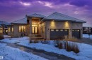 Modern home featuring a chimney, stone siding, a garage, and concrete driveway - 2796 Wheaton Drive, Edmonton, AB  - Outdoor 