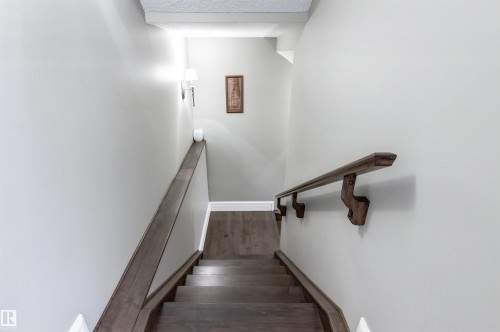 Stairs featuring a textured ceiling and wood finished floors - 2796 Wheaton Drive, Edmonton, AB - Indoor Photo Showing Other Room