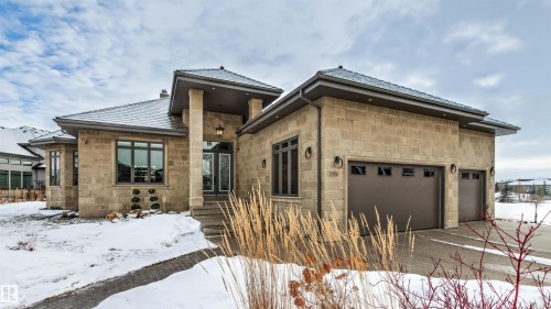 View of front of property featuring stone siding and a garage - 2796 Wheaton Drive, Edmonton, AB - Outdoor