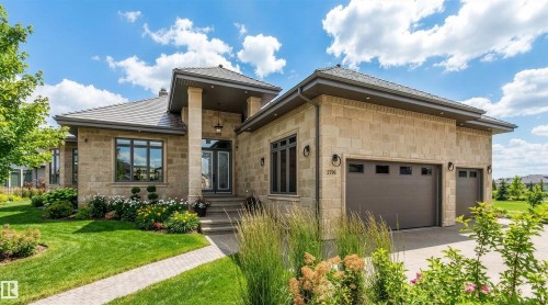 View of front of property with stone siding, a front yard, driveway, and an attached garage - 2796 Wheaton Drive, Edmonton, AB - Outdoor