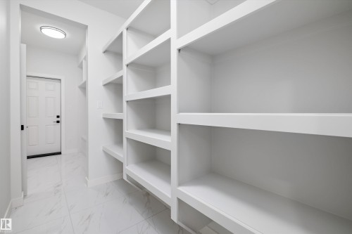 Walk in closet featuring light marble finish floors - 230 Edgemont Green Green Nw, Edmonton, AB - Indoor With Storage
