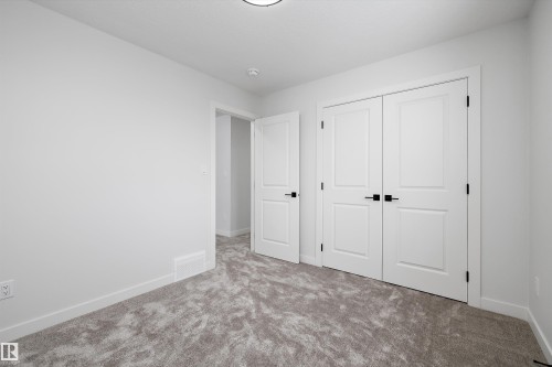 Unfurnished bedroom featuring carpet and a closet - 230 Edgemont Green Green Nw, Edmonton, AB - Indoor Photo Showing Other Room