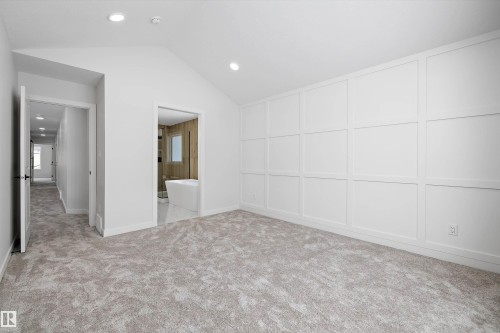 Unfurnished room featuring vaulted ceiling, light carpet, and recessed lighting - 230 Edgemont Green Green Nw, Edmonton, AB - Indoor Photo Showing Other Room