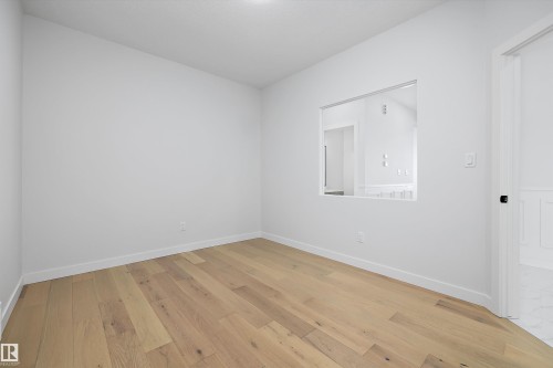 Empty room with light wood-type flooring and baseboards - 230 Edgemont Green Green Nw, Edmonton, AB - Indoor Photo Showing Other Room