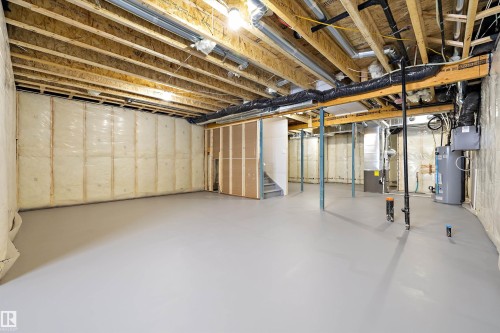 Unfinished basement featuring water heater and heating unit - 230 Edgemont Green Green Nw, Edmonton, AB - Indoor Photo Showing Basement