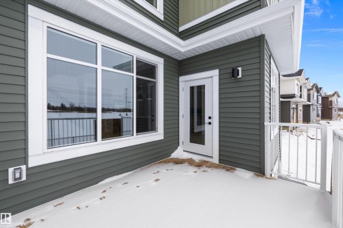 Snow covered property entrance with a deck - 230 Edgemont Green Green Nw, Edmonton, AB - Outdoor With Exterior