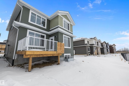 Snow covered back of property featuring a deck and a residential view - 230 Edgemont Green Green Nw, Edmonton, AB - Outdoor With Deck Patio Veranda