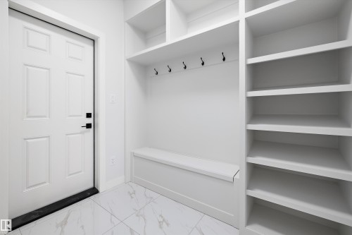 Mudroom with light marble finish floors and baseboards - 230 Edgemont Green Green Nw, Edmonton, AB - Indoor With Storage