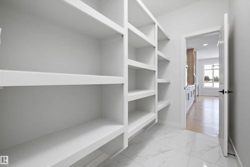 Walk in closet with light marble finish flooring - 230 Edgemont Green Green Nw, Edmonton, AB - Indoor With Storage