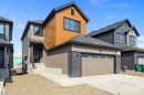View of front of home with roof with shingles, stone siding, concrete driveway, and an attached garage - 38 Cannes Cove, St. Albert, AB  - Outdoor 