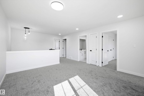 Carpeted spare room featuring baseboards and recessed lighting - 38 Cannes Cove, St. Albert, AB - Indoor Photo Showing Other Room
