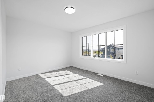 Carpeted spare room featuring baseboards - 38 Cannes Cove, St. Albert, AB - Indoor Photo Showing Other Room