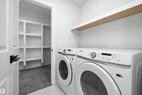 Washroom featuring independent washer and dryer and light marble finish flooring - 38 Cannes Cove, St. Albert, AB - Indoor Photo Showing Laundry Room