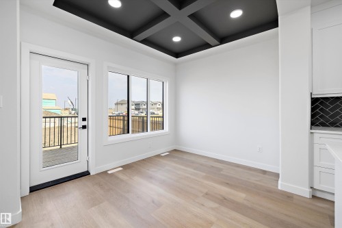 Unfurnished dining area with coffered ceiling, recessed lighting, light wood-type flooring, and beam ceiling - 38 Cannes Cove, St. Albert, AB - Indoor Photo Showing Other Room