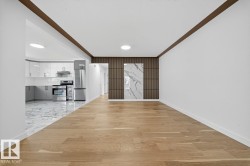 Unfurnished living room featuring light wood-style floors, ornamental molding, and recessed lighting - 