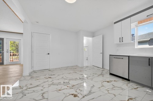 Kitchen featuring healthy amount of natural light, white cabinetry, dishwasher, and backsplash - 12919 113A Street, Edmonton, AB - Indoor