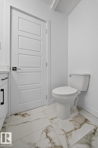 Half bath featuring light marble finish flooring and vanity - 12919 113A Street, Edmonton, AB - Indoor Photo Showing Bathroom