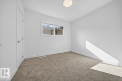 Unfurnished bedroom featuring baseboards and light carpet - 