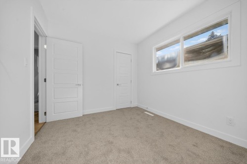 Unfurnished bedroom featuring baseboards and carpet floors - 12919 113A Street, Edmonton, AB - Indoor Photo Showing Other Room