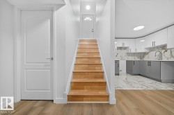 Stairs featuring wood finished floors - 