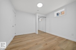 Unfurnished bedroom featuring light wood finished floors and a closet - 