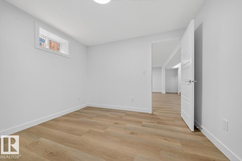 Unfurnished room featuring light wood-type flooring and baseboards - 12919 113A Street, Edmonton, AB - Indoor Photo Showing Other Room