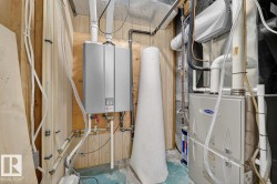 Utility room with heating unit and tankless water heater - 