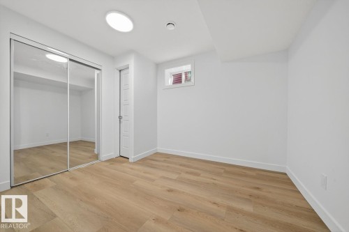 Unfurnished bedroom featuring light wood-style floors and a closet - 12919 113A Street, Edmonton, AB - Indoor Photo Showing Other Room