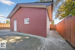 View of property exterior featuring a fenced backyard and a gate - 