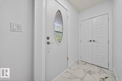 Entrance foyer with light marble finish floors and baseboards - 12919 113A Street, Edmonton, AB - Indoor Photo Showing Other Room