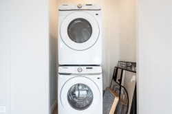 Laundry area with stacked washing machine and dryer - 