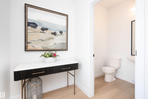 Half bath featuring light wood-type flooring - 64 18120 28 Avenue Sw, Edmonton, AB - Indoor Photo Showing Bathroom