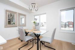 Dining area featuring light wood-type flooring and a chandelier - 