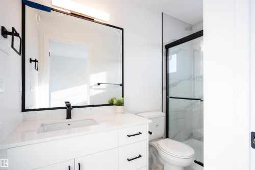 Bathroom featuring a stall shower and vanity - 64 18120 28 Avenue Sw, Edmonton, AB - Indoor Photo Showing Bathroom