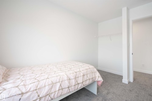 Bedroom featuring carpet flooring and baseboards - 64 18120 28 Avenue Sw, Edmonton, AB - Indoor Photo Showing Bedroom