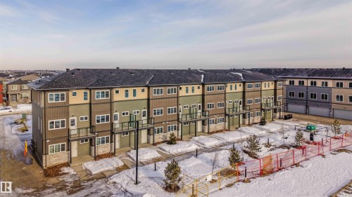 Snow covered building with a view of apartment building / complex - 64 18120 28 Avenue Sw, Edmonton, AB - Outdoor