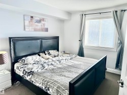 Bedroom featuring a textured ceiling and baseboards - 