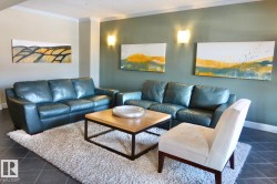 Living area with dark tile patterned flooring and crown molding - 
